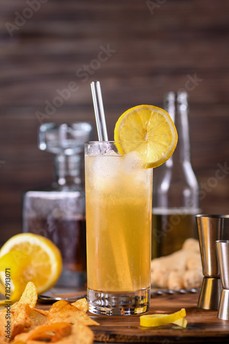 Whiskey cocktail with ginger beer, garnished with lemon 