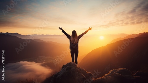 Woman on top of the mountain with sunrise success in business 