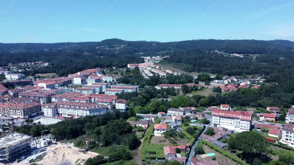 Bird's eye view of houses on green hills on a sunny day in Ames, Spain Bird's eye view of houses on green hills on a sunny day in Ames, Spain
