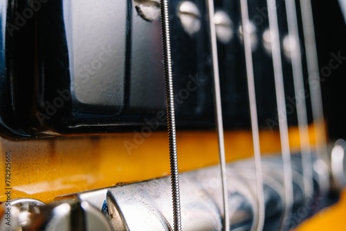 Closeup shot of a classical acoustic guitar strings and the bridge photo