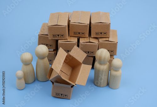 Family wooden people figures and many shipping carton boxes.
