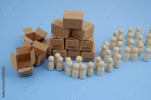 Many shipping carton boxes and wooden people figures. Donation and charity concept.