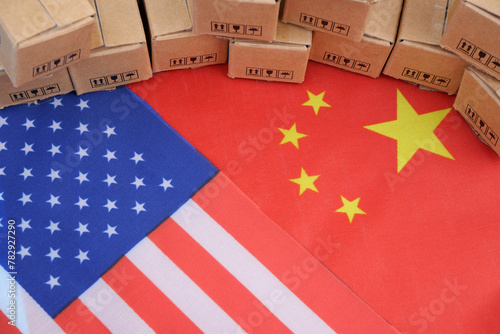 Trade between china and USA. Flags on USA and China and many shipping carton boxes close up.	