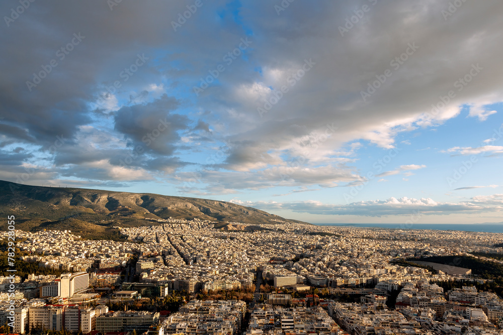 Majestic sunset with marvellous clouds over Hymettus mount and Athens city, Greece. There are several districts included like Ilioupoli, Pagkrati, Ilisia, Hilton, Kesariani, Vyronas and Kareas.