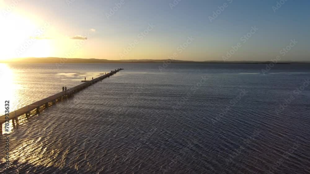 Aerial view of a wooden dock going out into the Tuggerah Lake in Australia Aerial view of a wooden dock going out into the Tuggerah Lake in Australia