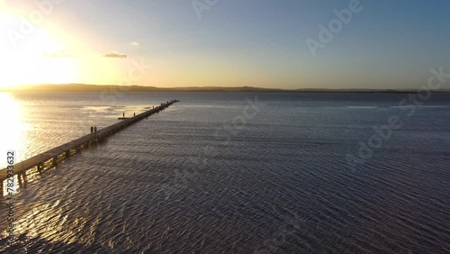 Aerial view of a wooden dock going out into the Tuggerah Lake in Australia photo