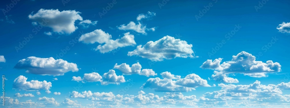 The sky is a vivid blue, clear and expansive, with scattered cumulus clouds