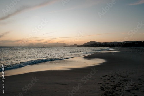 Beautiful shot of Camboinhas beach and sea with mountain in the background at sunset