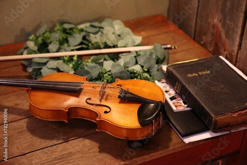 Cello and the Holy Bible on a wooden table