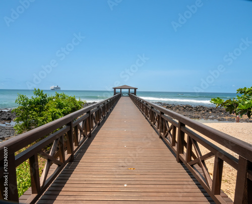 Boardwalk on a beach in S  o Tom   with a cruise ship in the background  S  o Tom   and Principe  STP   Central Africa