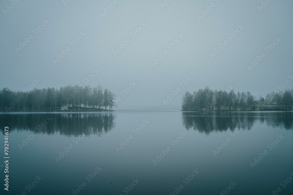 Lake with reflections on a foggy day