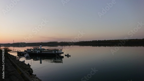 Panoramic view of Radetzky ship near Kozloduy coast of Danube River at sunset photo