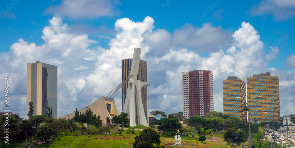The modern skyline of the plateau district of Abidjan with St. Paul Cathedral in the foreground Abidjan, Côte d'ivoire (Ivory Coast), West Africa
