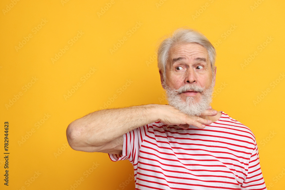 Senior man with mustache on orange background Senior man with mustache on orange background