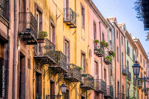 Balconies and windows on old buildings in italian town in Sardinia.