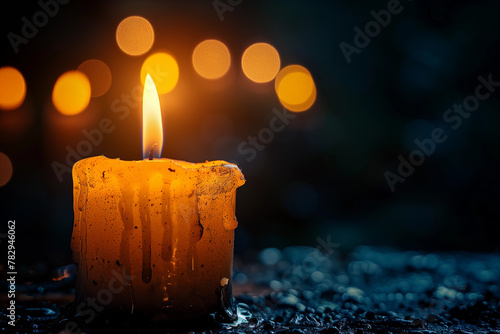 Single white burning candle on black background