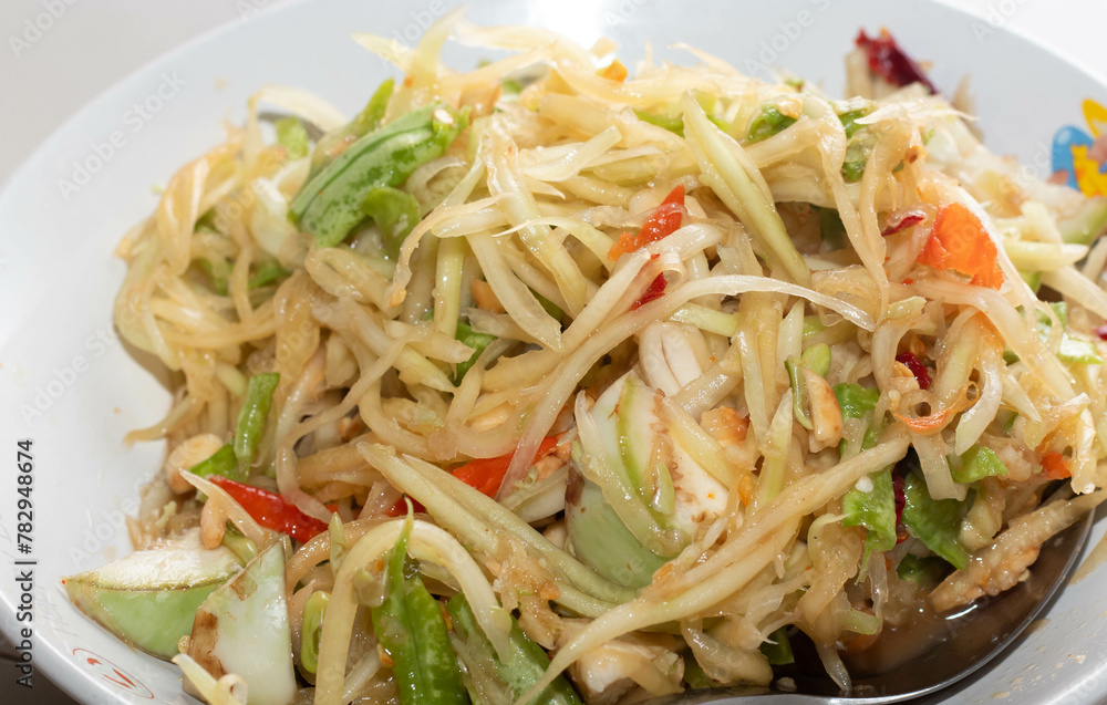 papaya salad on a white plate papaya salad on a white plate