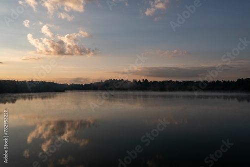 Fototapeta Naklejka Na Ścianę i Meble -  Beautiful view of a lake with a reflection of the sunset sky