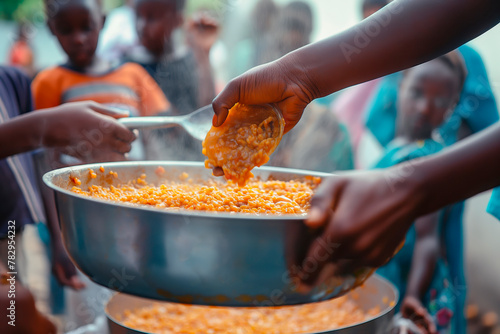 Volunteers feed African children. Problems of hunger and lack of food in African countries