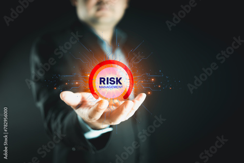 Businessman holding virtual risk management as strategy to avoid data loss. Risk Management, planning for enterprise strategy and financial assessment in international business