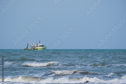 Fishing boat sailing in rough seas