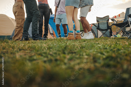 Group of young people standing together at a music festival camp photo
