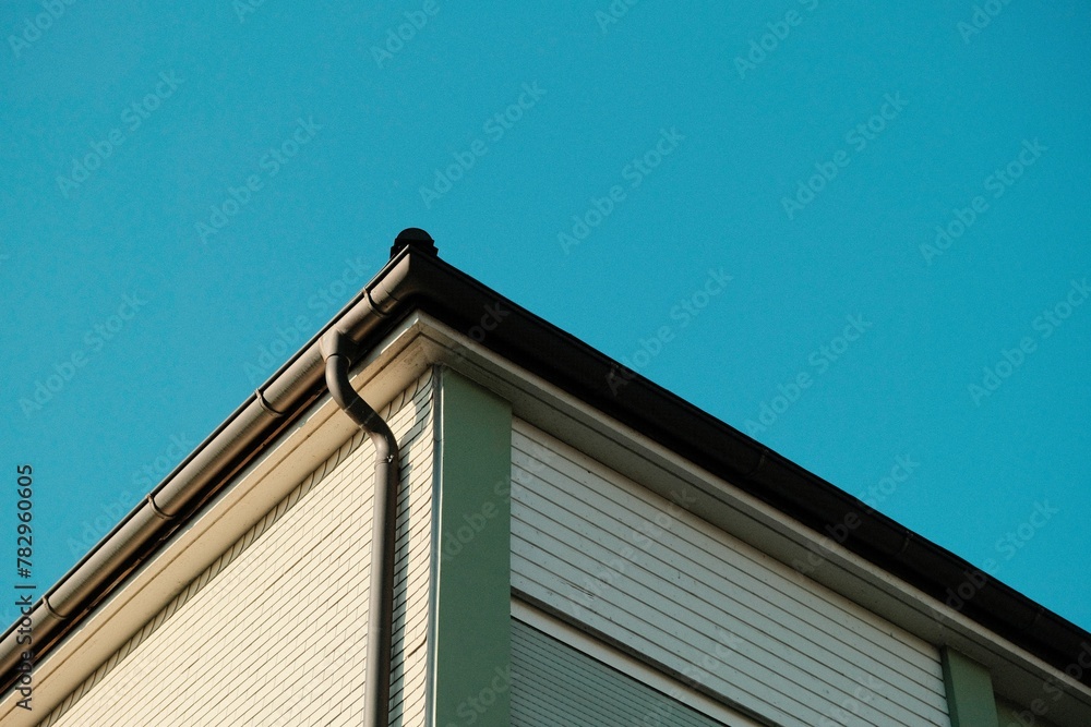 Corner of house against a blue clear sky Corner of house against a blue clear sky