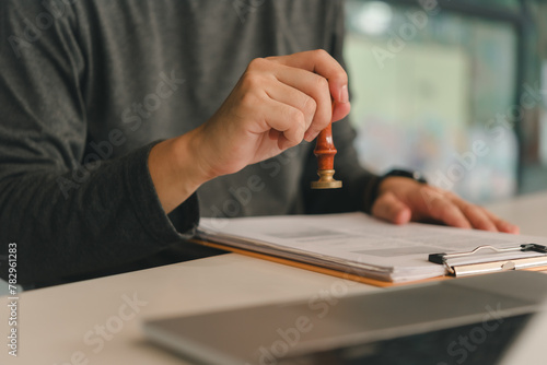 Contract law or paper work business and finance document rubber stamp. For official and legal contracts and agreements, financial statements, investment contracts, real estate documents.