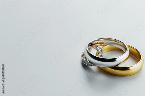 Two gold and silver wedding rings on a plain white background. Ideal for wedding or jewelry concepts