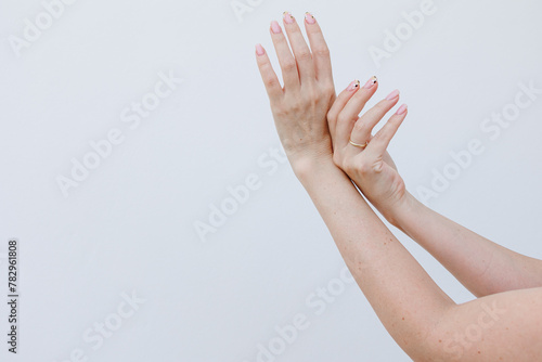 Female hands above white background