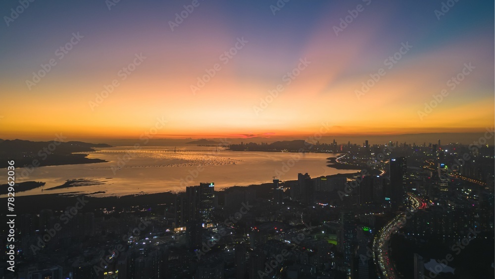 Mesmerizing scene of Sunset on cityscape with seaside, perfect for background