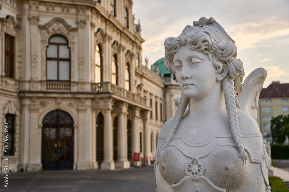 Closeup of a statue in front of the Upper Belvedere building