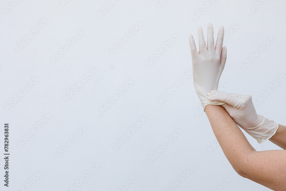 Female hands wearing disposable gloves Female hands wearing disposable gloves