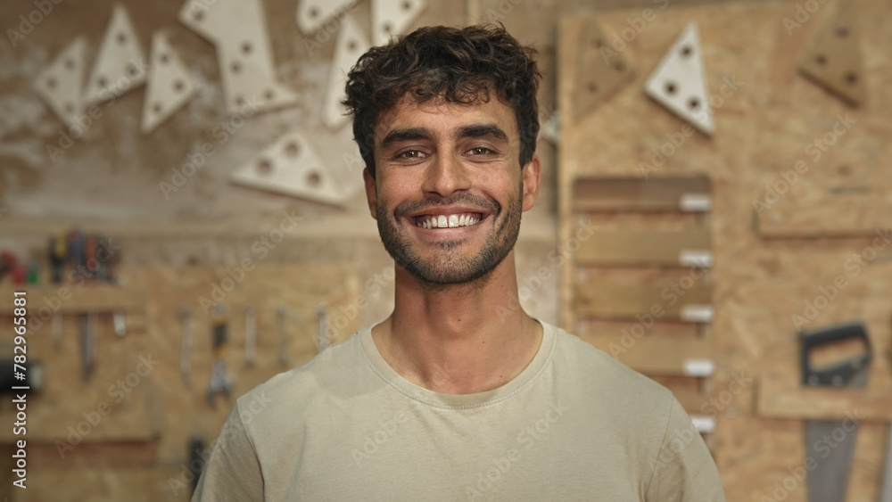 Obraz premium Man carpenter face portrait. Male carpentry work skill. Joiner guy timber woodwork. Happy worker smile. Serious person woodworker look at camera. Wood diy master class workshop. Many tools background.
