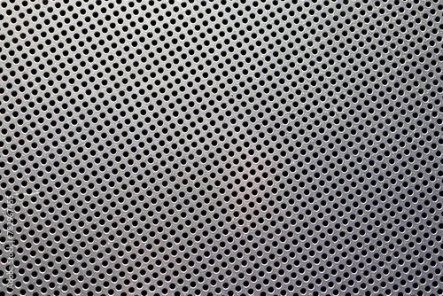 Background of grey metal with holes.