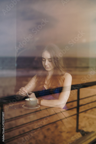 Woman drinking tea sitting in a cafe
