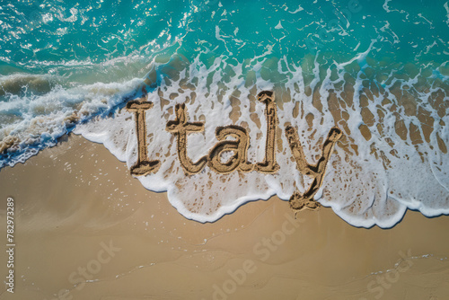 Italy written in the sand on a beach. Italian tourism and vacation background