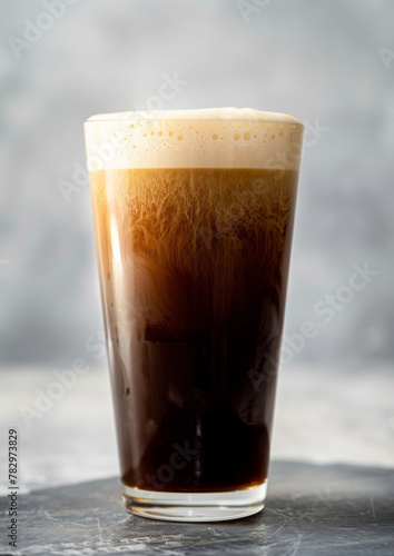 Product photo of nitro cold brew coffee, on slate surface, isolated on white background. studio lighting. © steve