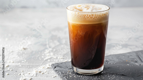 Product photo of nitro cold brew coffee, on slate surface, isolated on white background. studio lighting. photo