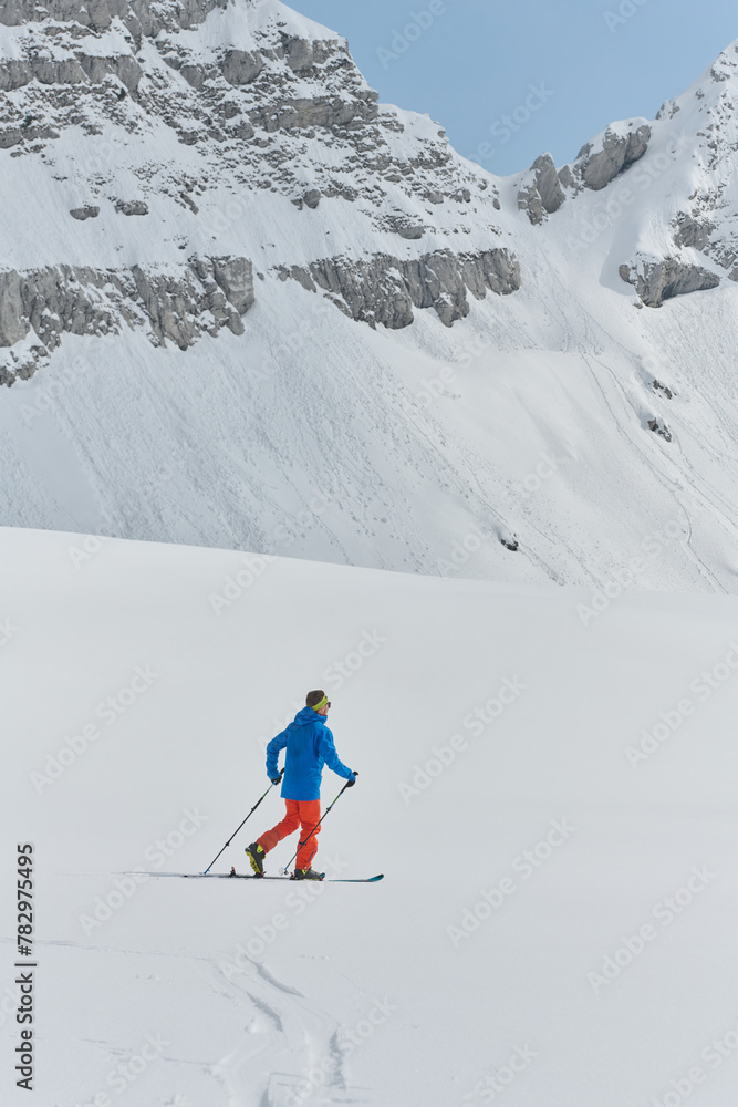 A Skier Scales a Treacherous Alpine Peak