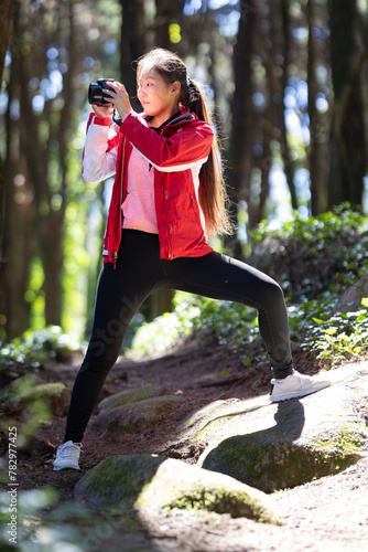 Woman photographer in Red Jacket Doing Yoga Pose