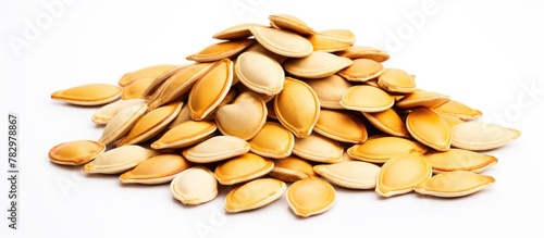 Pumpkin seeds on a white ba...