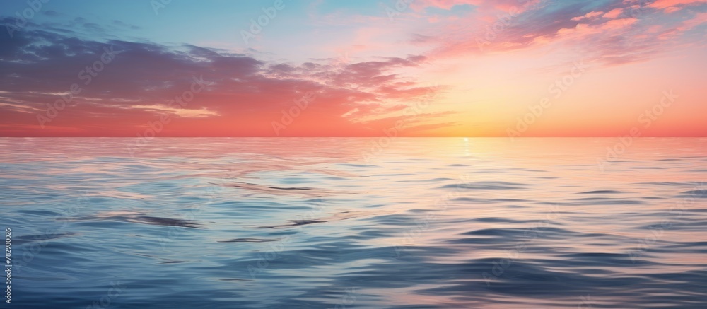 Sunset glow on ocean with distant boat