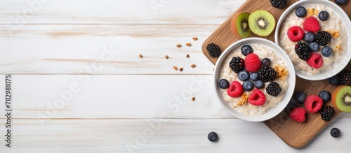Healthy oatmeal bowls with fresh berries and kiwis
