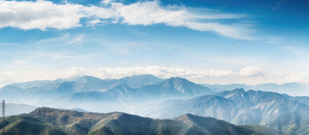 Mountains with a blue sky and clouds in the background