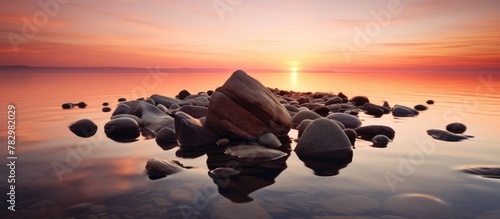 Sunset on rocky shore with diverse rocks photo
