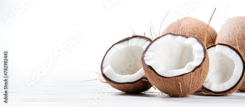 Three halved coconuts on wh...