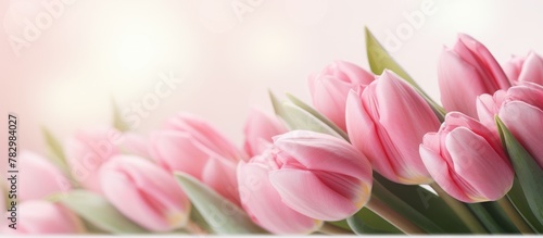 Pink tulips arranged in vas...