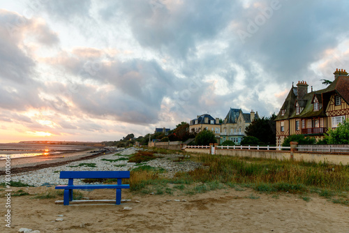 Sunrise view of coastal street of Grandcamp Maisy, a scenic French coastal town in Normandy, with fishing port, sandy beaches, and maritime traditions.