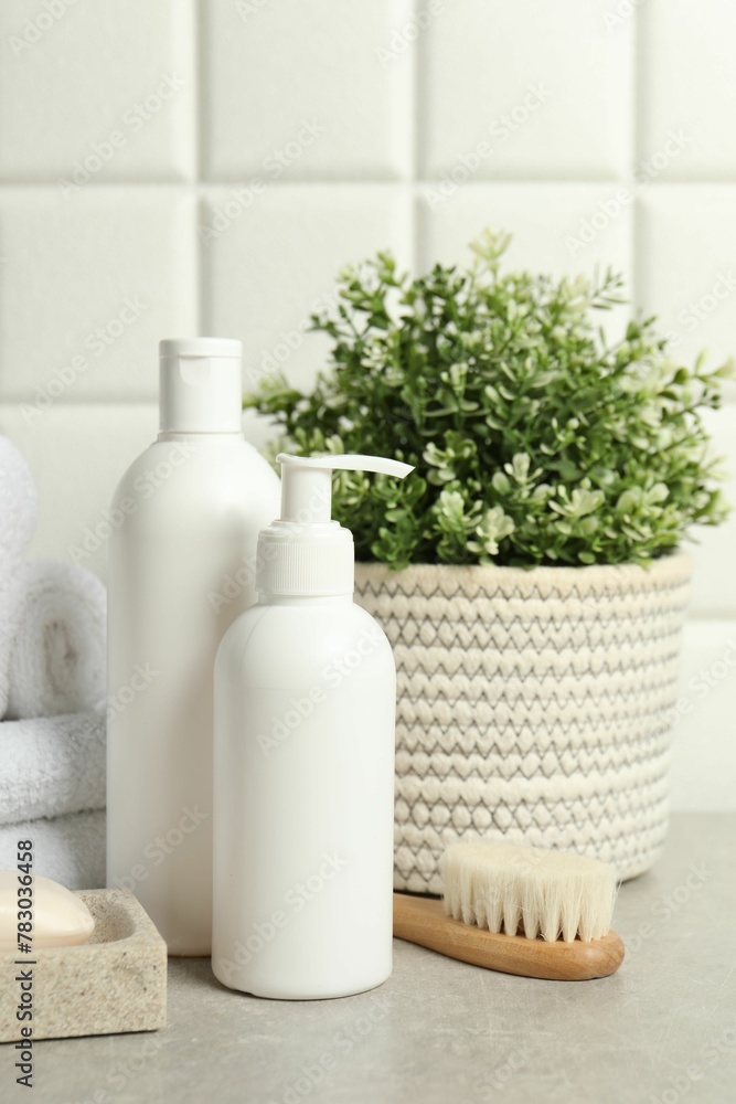Different bath accessories and personal care products on gray table Different bath accessories and personal care products on gray table
